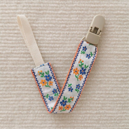 attache tetine orange bleu